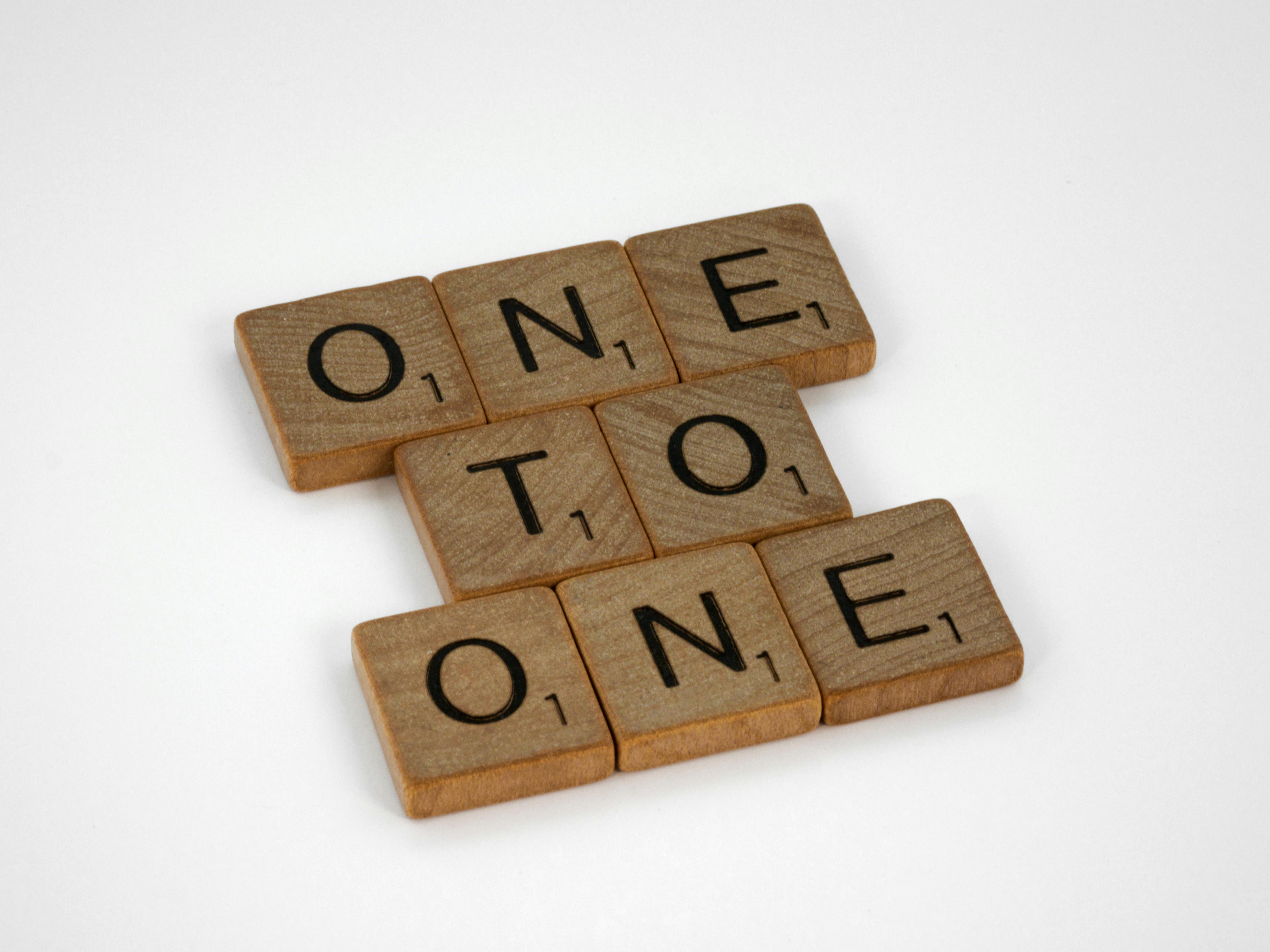 a photo of Scrabble tiles that spell “one to one”